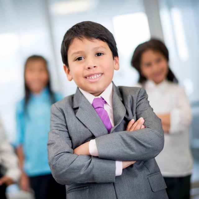 Group of kids in business clothing in a office setting