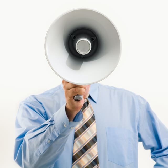 Man holding bullhorn that covers his face