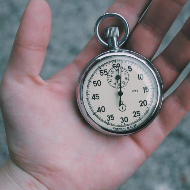 Hand holding stopwatch
