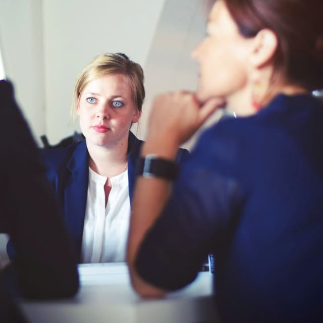 Woman staring at others in a meeting