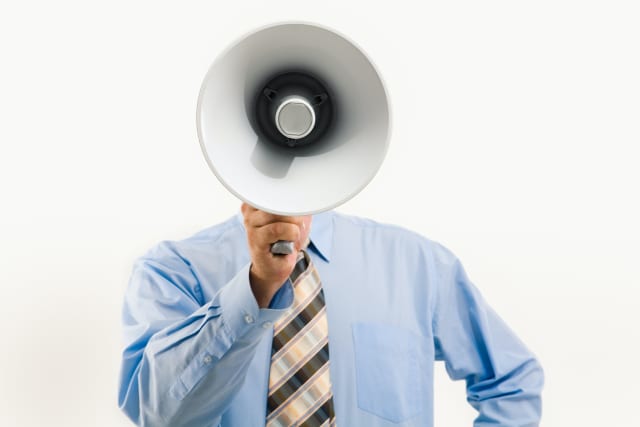 Man holding bullhorn that covers his face