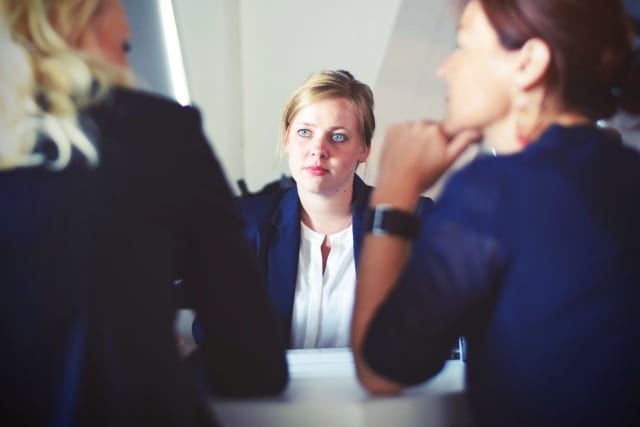 Woman staring at others in a meeting