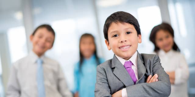 Group of kids in business clothing in a office setting
