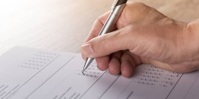 Person checking off a checklist